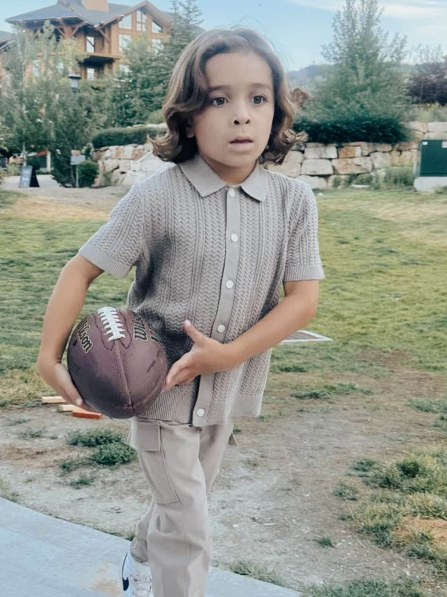 little boy carrying football