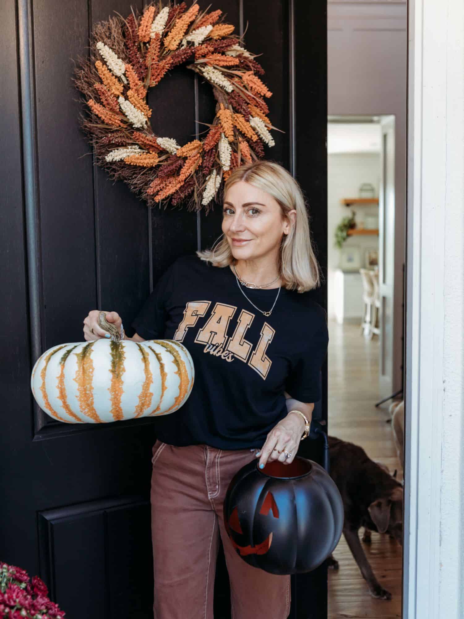 woman standing with pumpkin