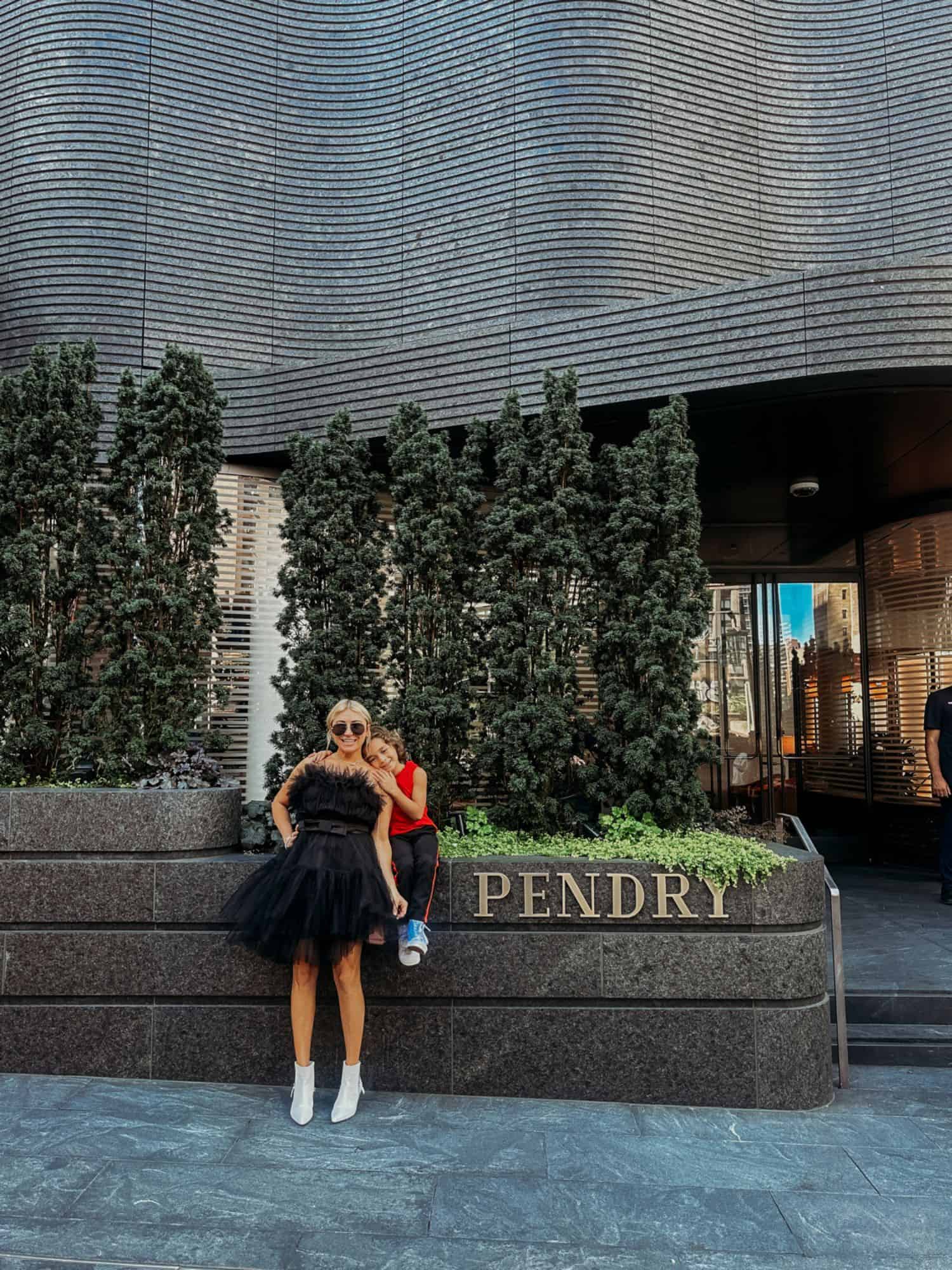 woman and boy standing outside the hotel