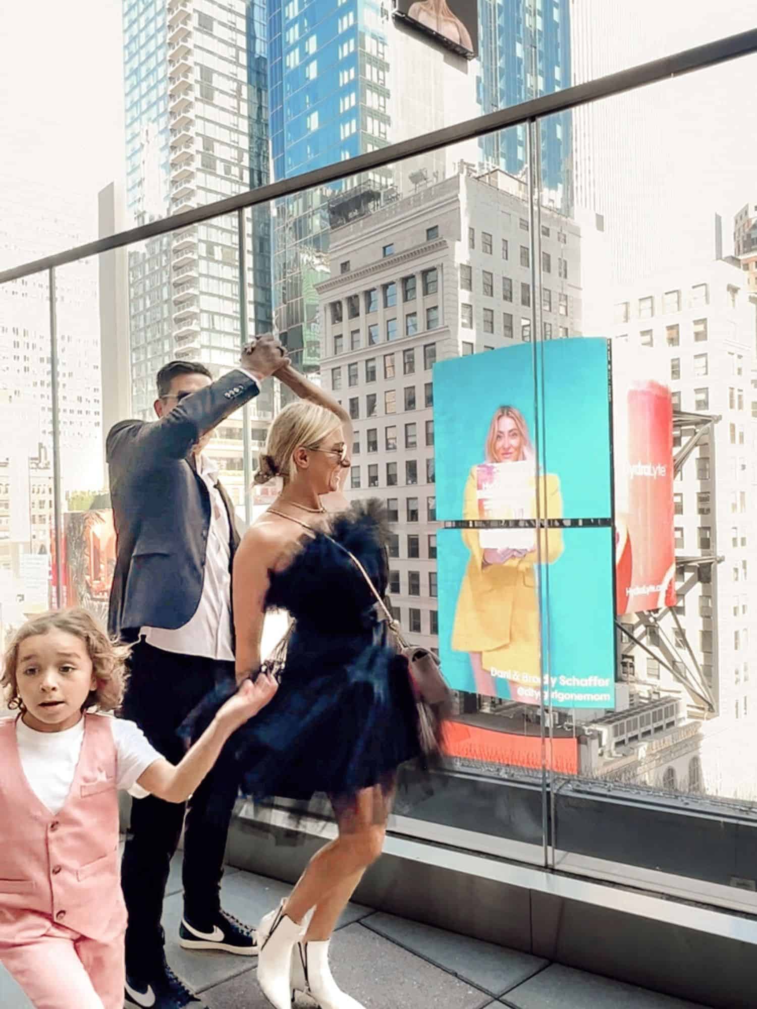 family dancing in front of sign