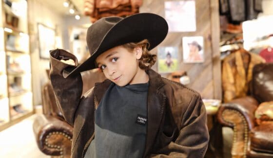 boy in leather jacket and cowboy hat