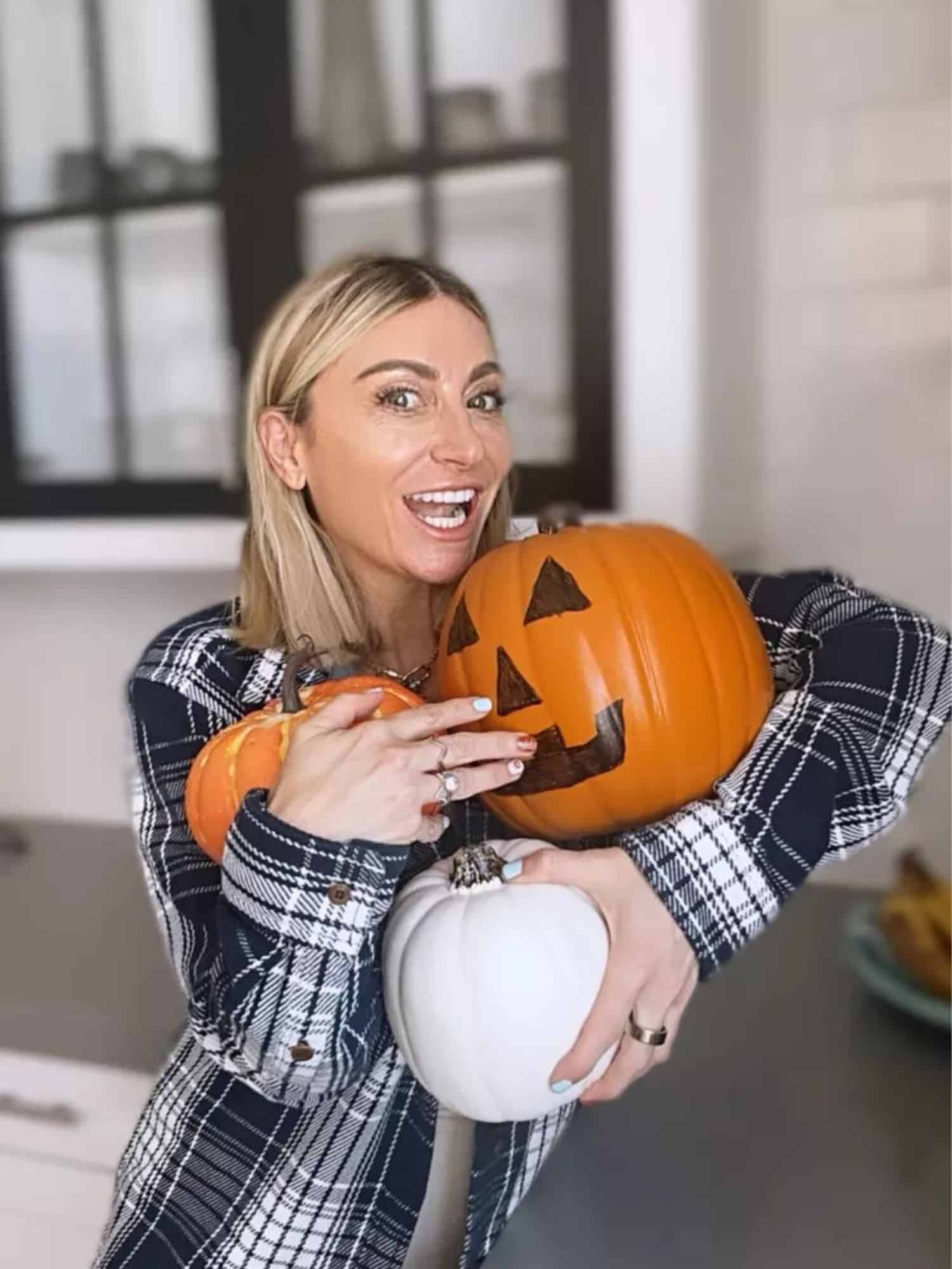 woman holding pumpkins