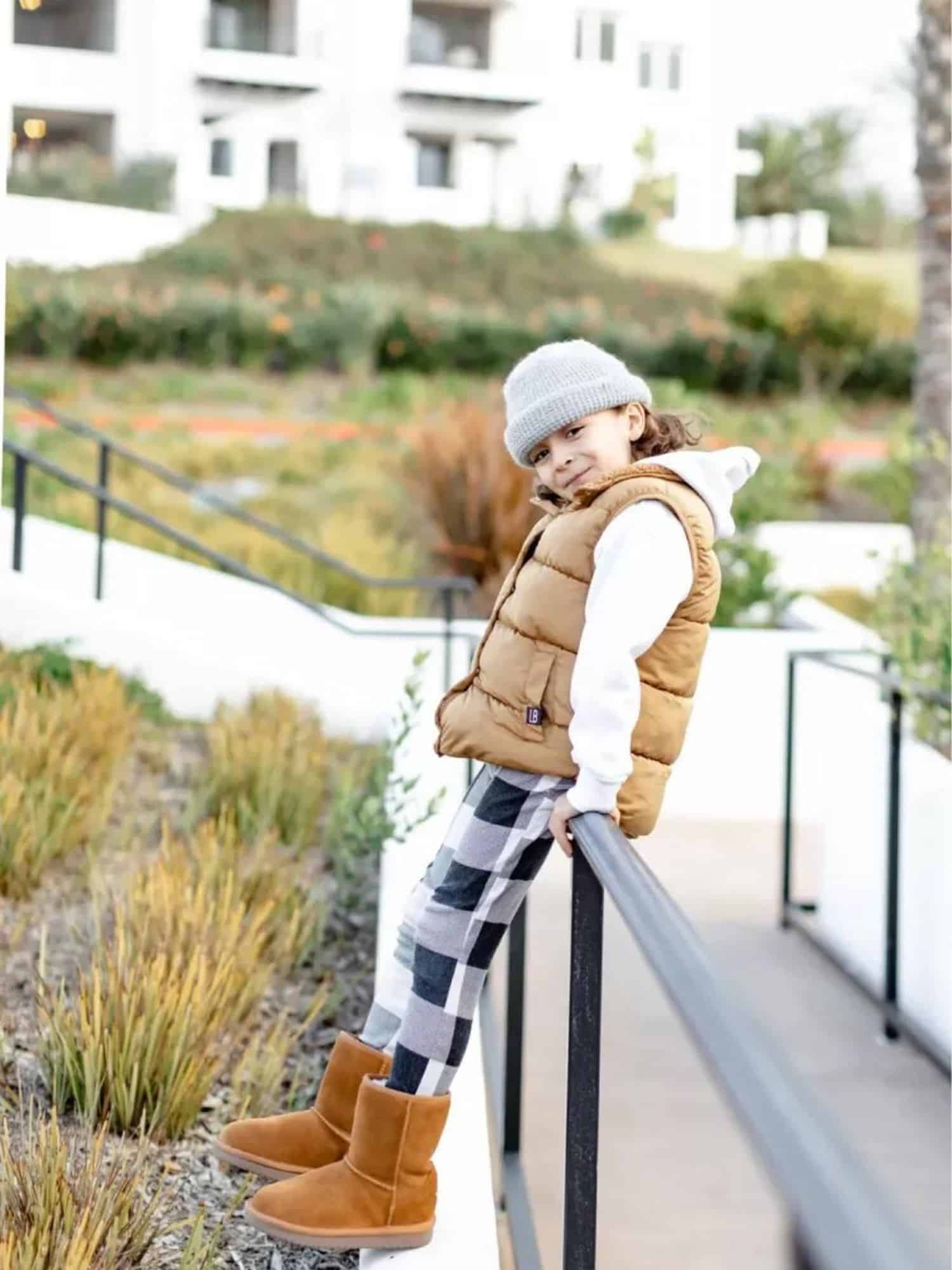 boy sitting on side of side walk