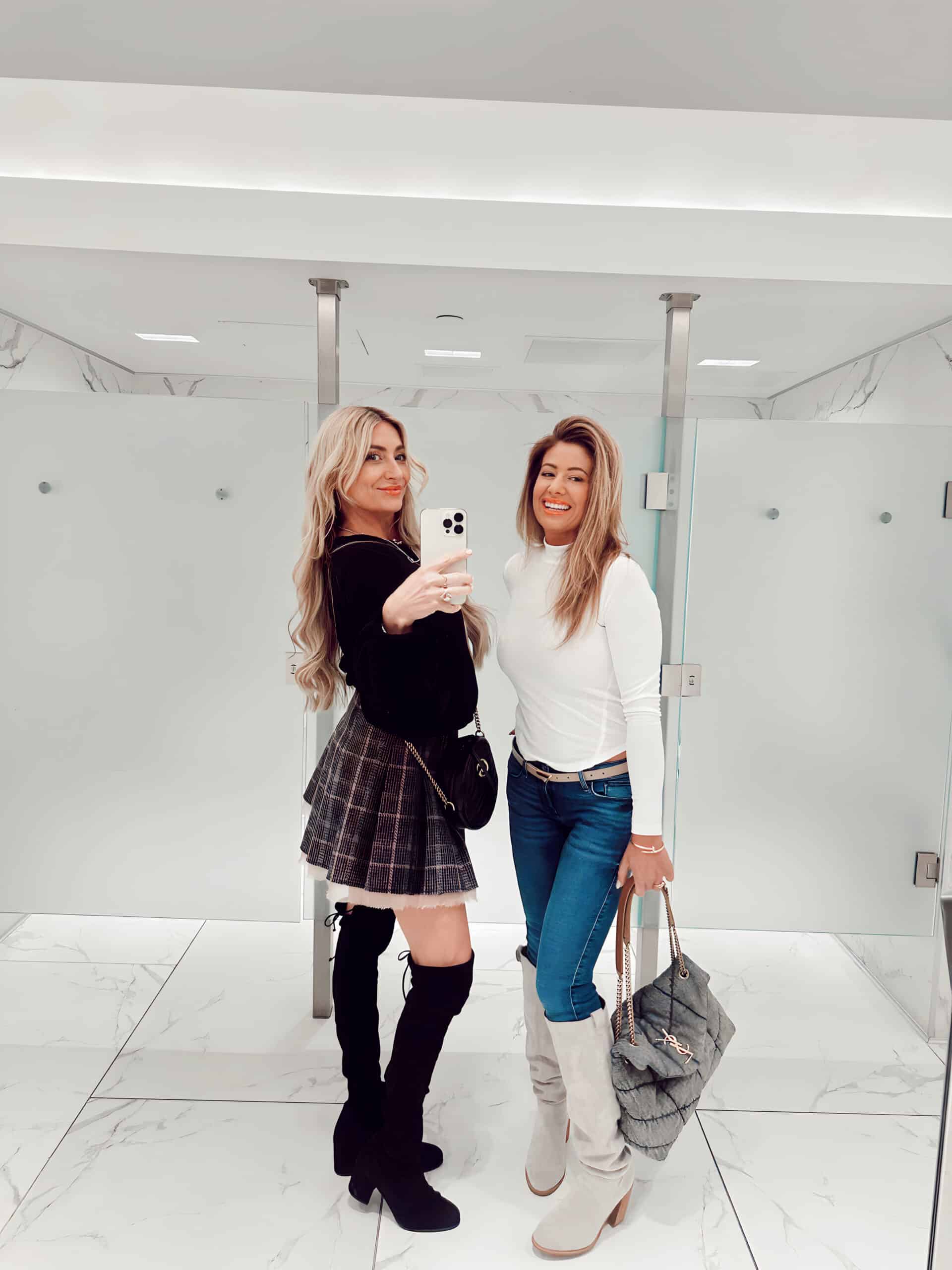 2 woman standing together in a bathroom