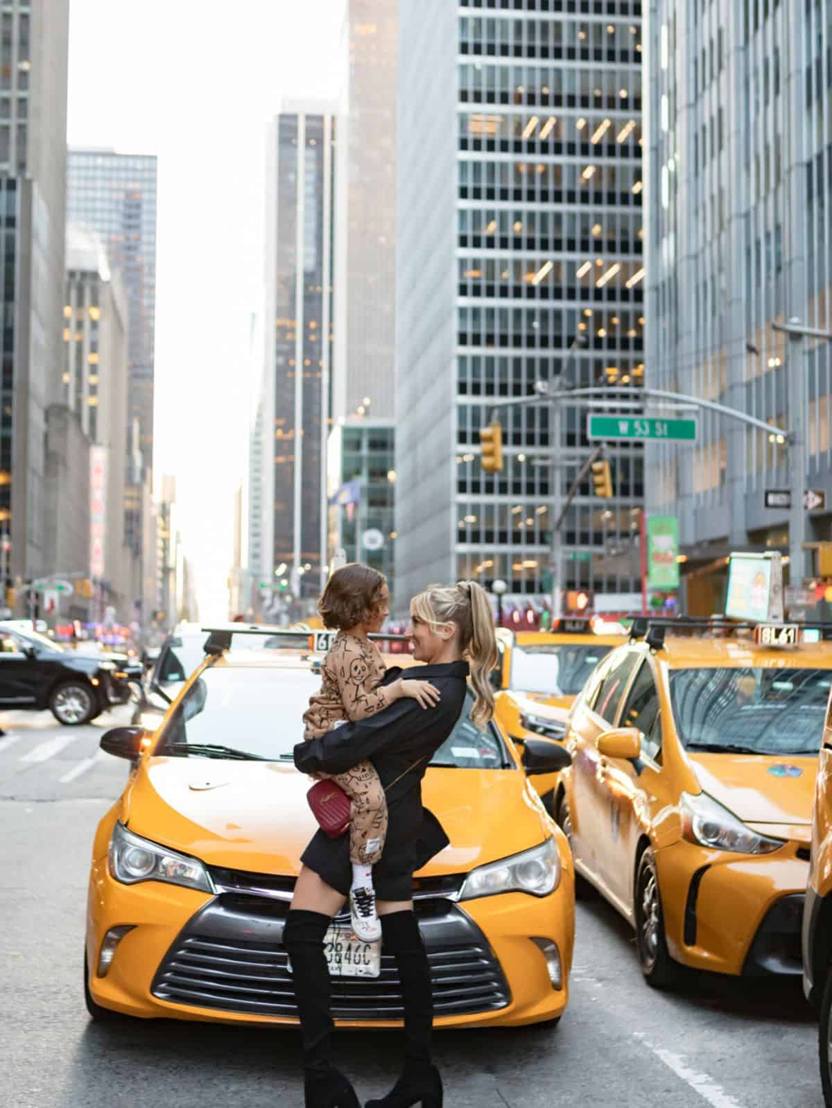 woman and child in front of a taxi