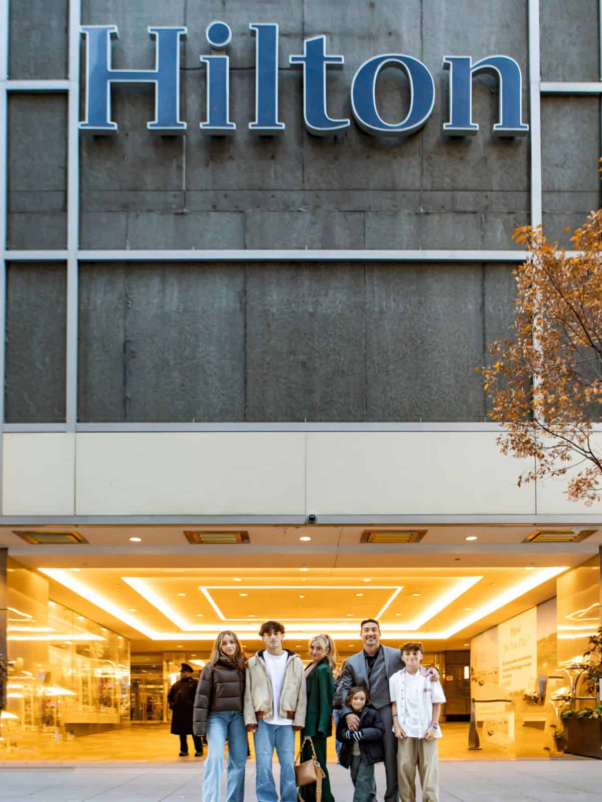 family standing in front of hilton building