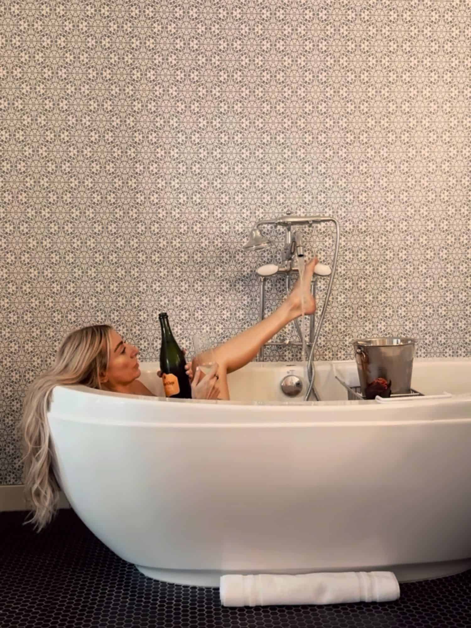 women in the tub with bottle